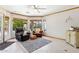 Bright living room featuring comfortable leather chairs, ceiling fan and large windows at 3736 W Angela Dr, Glendale, AZ 85308
