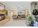 Cozy living room with a stone fireplace, comfortable seating, and tile flooring at 3736 W Angela Dr, Glendale, AZ 85308