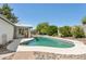 Backyard pool with surrounding stone and brick landscaping and patio area for outdoor enjoyment at 3736 W Angela Dr, Glendale, AZ 85308