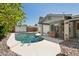 Backyard pool with stone surround, adjacent to home's covered patio at 3736 W Angela Dr, Glendale, AZ 85308
