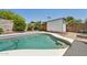 Backyard pool area with desert landscaping and a storage shed at 3736 W Angela Dr, Glendale, AZ 85308