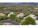 Scenic aerial view showcases the property's lush landscaping and the stunning mountain backdrop at 39016 N Habitat Cir, Cave Creek, AZ 85331