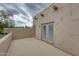 View of balcony with stucco walls, wood beams and double doors leading to interior at 39016 N Habitat Cir, Cave Creek, AZ 85331
