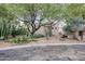 Landscaped front yard with cacti, desert plants, and a mature shade tree at 39016 N Habitat Cir, Cave Creek, AZ 85331