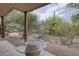 Covered patio with a stone table and chairs offers a relaxing outdoor living space at 39016 N Habitat Cir, Cave Creek, AZ 85331