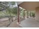 Inviting covered patio with wooden support beams overlooking the natural landscape, creating a peaceful retreat at 39016 N Habitat Cir, Cave Creek, AZ 85331