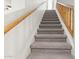 Carpeted staircase features wood banisters leading to a bright, upper level at 39016 N Habitat Cir, Cave Creek, AZ 85331