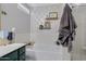 This bathroom showcases a soaking tub, decorative wallpaper, and glass-enclosed shower at 4030 E Meadow Creek Way, San Tan Valley, AZ 85140