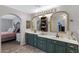 Bathroom vanity with dual sinks, framed mirrors and access to main bedroom at 4030 E Meadow Creek Way, San Tan Valley, AZ 85140