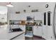 Well-lit kitchen featuring stainless steel appliances, white cabinets, and a charming pantry door at 4030 E Meadow Creek Way, San Tan Valley, AZ 85140