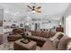 Bright living room with open floor plan, ceiling fan, and comfy seating area at 4030 E Meadow Creek Way, San Tan Valley, AZ 85140