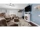 Inviting living room with a cozy fireplace, mounted TV, and comfortable sectional sofa at 4030 E Meadow Creek Way, San Tan Valley, AZ 85140