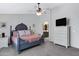 This main bedroom boasts a ceiling fan, carpeted flooring and a view of the bathroom at 4030 E Meadow Creek Way, San Tan Valley, AZ 85140