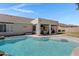 A private backyard with a refreshing pool and a covered patio perfect for outdoor relaxation and entertaining at 4030 E Meadow Creek Way, San Tan Valley, AZ 85140