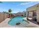 Backyard swimming pool with rock feature and covered patio at 4030 E Meadow Creek Way, San Tan Valley, AZ 85140