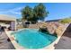 Backyard pool with rock waterfall feature and slide at 4030 E Meadow Creek Way, San Tan Valley, AZ 85140