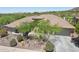 Aerial view of a home showcasing the desert landscaping, multiple garages, and overall property layout at 41602 N Congressional Dr, Phoenix, AZ 85086