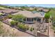 An aerial view of a desert home with a landscaped yard, tile roof, and modern solar panels at 41602 N Congressional Dr, Phoenix, AZ 85086