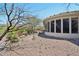 Backyard view highlighting the desert landscape and architecture, including a curved screened porch at 41602 N Congressional Dr, Phoenix, AZ 85086