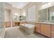 This bathroom includes a large soaking tub, dual vanities, and plenty of storage space at 41602 N Congressional Dr, Phoenix, AZ 85086