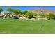 Beautiful lush golf course with a waterfall feature, trees, and mountain views in the background at 41602 N Congressional Dr, Phoenix, AZ 85086
