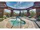 Inviting hot tub surrounded by comfortable seating and a shaded pergola for relaxation at 41602 N Congressional Dr, Phoenix, AZ 85086