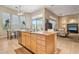 This kitchen features an island with granite countertops, wooden cabinets, and stainless steel appliances at 41602 N Congressional Dr, Phoenix, AZ 85086