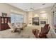 Living room with a fireplace and built-in shelving, with carpet flooring and natural light at 41602 N Congressional Dr, Phoenix, AZ 85086