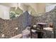 Stylish powder room featuring a stone accent wall and modern fixtures at 41602 N Congressional Dr, Phoenix, AZ 85086