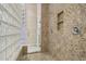 Beautiful walk-in shower with granite tiling and stylish glass-block wall at 41602 N Congressional Dr, Phoenix, AZ 85086