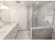 Modern bathroom featuring a glass-enclosed shower and sleek marble vanity at 4202 E Sahuaro Dr, Phoenix, AZ 85028