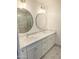 Bright bathroom with double sinks, marble countertops, and a large frameless glass shower at 4202 E Sahuaro Dr, Phoenix, AZ 85028