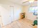 Bedroom with wood floors, closet with sliding doors, and a ceiling fan at 4202 E Sahuaro Dr, Phoenix, AZ 85028