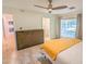 Comfortable bedroom featuring a view to the back patio with ensuite bathroom access at 4202 E Sahuaro Dr, Phoenix, AZ 85028