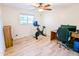 Bright bedroom featuring wood floors, ceiling fan, and natural light from the window at 4202 E Sahuaro Dr, Phoenix, AZ 85028