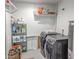 Functional laundry room with shelving, a washing machine, and a dryer at 4202 E Sahuaro Dr, Phoenix, AZ 85028