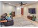 Cozy living room with a leather sofa, patterned rug, and decorative accents at 4202 E Sahuaro Dr, Phoenix, AZ 85028