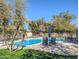 Refreshing backyard pool with a safety fence, patio furniture and lush greenery at 4202 E Sahuaro Dr, Phoenix, AZ 85028