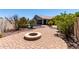 Backyard featuring desert landscaping, a fire pit, and a covered patio at 44468 W Eddie Way, Maricopa, AZ 85138