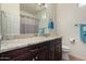 Bathroom featuring granite countertop, dark wood cabinetry, a mirror, and a toilet at 44468 W Eddie Way, Maricopa, AZ 85138