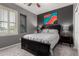 Comfortable bedroom with a ceiling fan, a statement art piece, and a window at 44468 W Eddie Way, Maricopa, AZ 85138