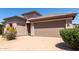 Attractive home exterior showing a brick paved driveway leading to a two car garage and desert landscaping at 44468 W Eddie Way, Maricopa, AZ 85138