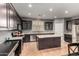 Gourmet kitchen featuring granite countertops, stainless steel appliances, and dark wood cabinets for a modern look at 44468 W Eddie Way, Maricopa, AZ 85138