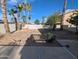 Large backyard featuring desert landscaping, mature palm trees, and a patio area for entertaining at 4636 E Carmen St, Phoenix, AZ 85044
