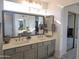 Bright bathroom featuring double sinks, large mirror, with plenty of natural light at 4636 E Carmen St, Phoenix, AZ 85044