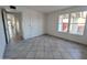 Bright bedroom with tile flooring, double windows, and natural light at 4636 E Carmen St, Phoenix, AZ 85044