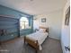 Cozy bedroom with carpet flooring, a window seat and a built-in bookshelf at 4636 E Carmen St, Phoenix, AZ 85044