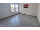 Simple bedroom with light walls, tile flooring, and double windows offering natural light at 4636 E Carmen St, Phoenix, AZ 85044