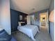 Comfortable bedroom with carpet floors, a window seat and stylish lighting and an ensuite bath at 4636 E Carmen St, Phoenix, AZ 85044