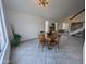 Bright dining area with tile floors, a decorative fireplace and a wood table with four chairs at 4636 E Carmen St, Phoenix, AZ 85044
